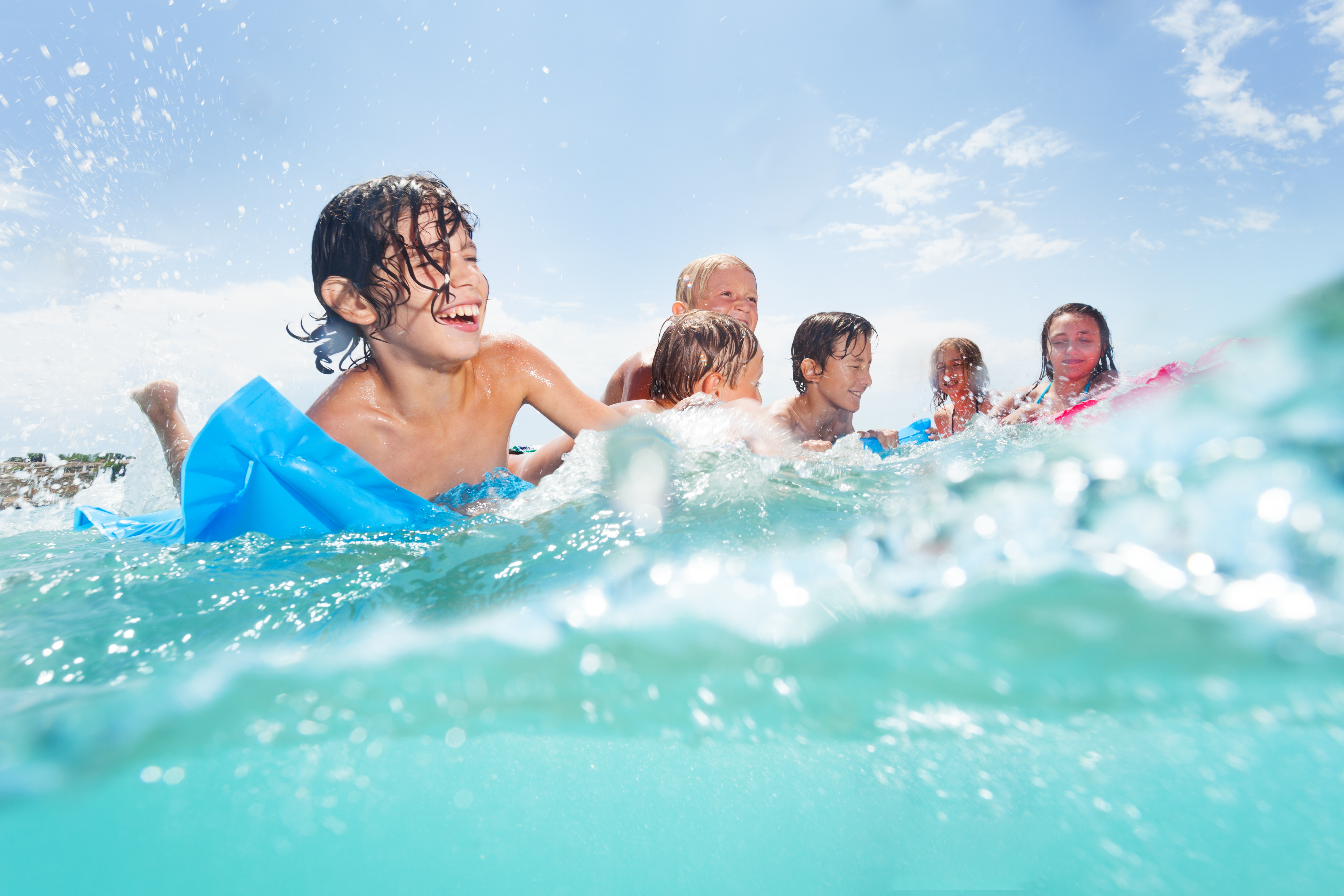 Kids playing in the ocean on the Emerald Coast